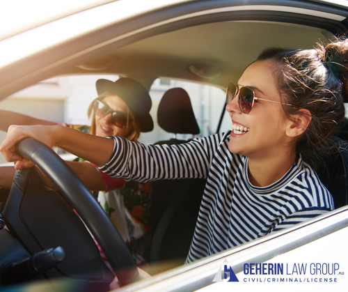 Female driver happy behind the wheel of a car