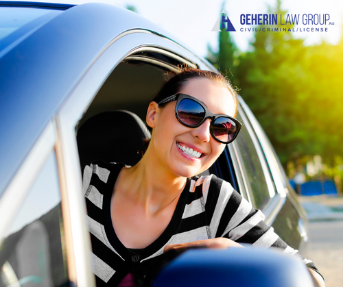 Happy driver poking their head out the driver side window smiling