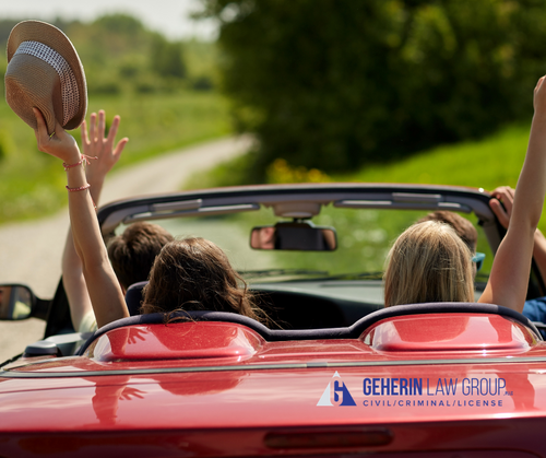 Friends driving in a red corvette on a sunny day with the top down
